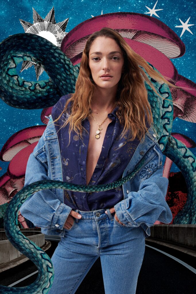 A relaxed blue denim jacket layered over a collared shirt, featuring a buttoned design.