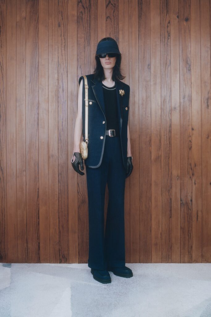 A fitted black sleeveless vest paired with navy wide-leg pants, creating a stylish ensemble.