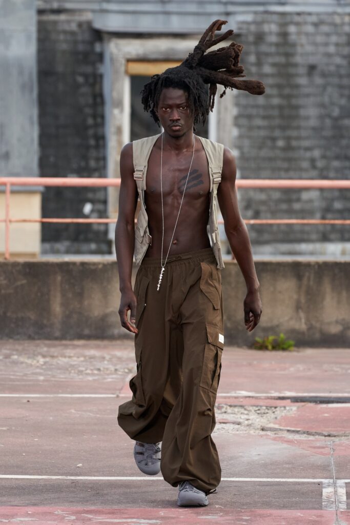 A relaxed brown cotton sleeveless vest paired with wide-leg pants for a casual look.