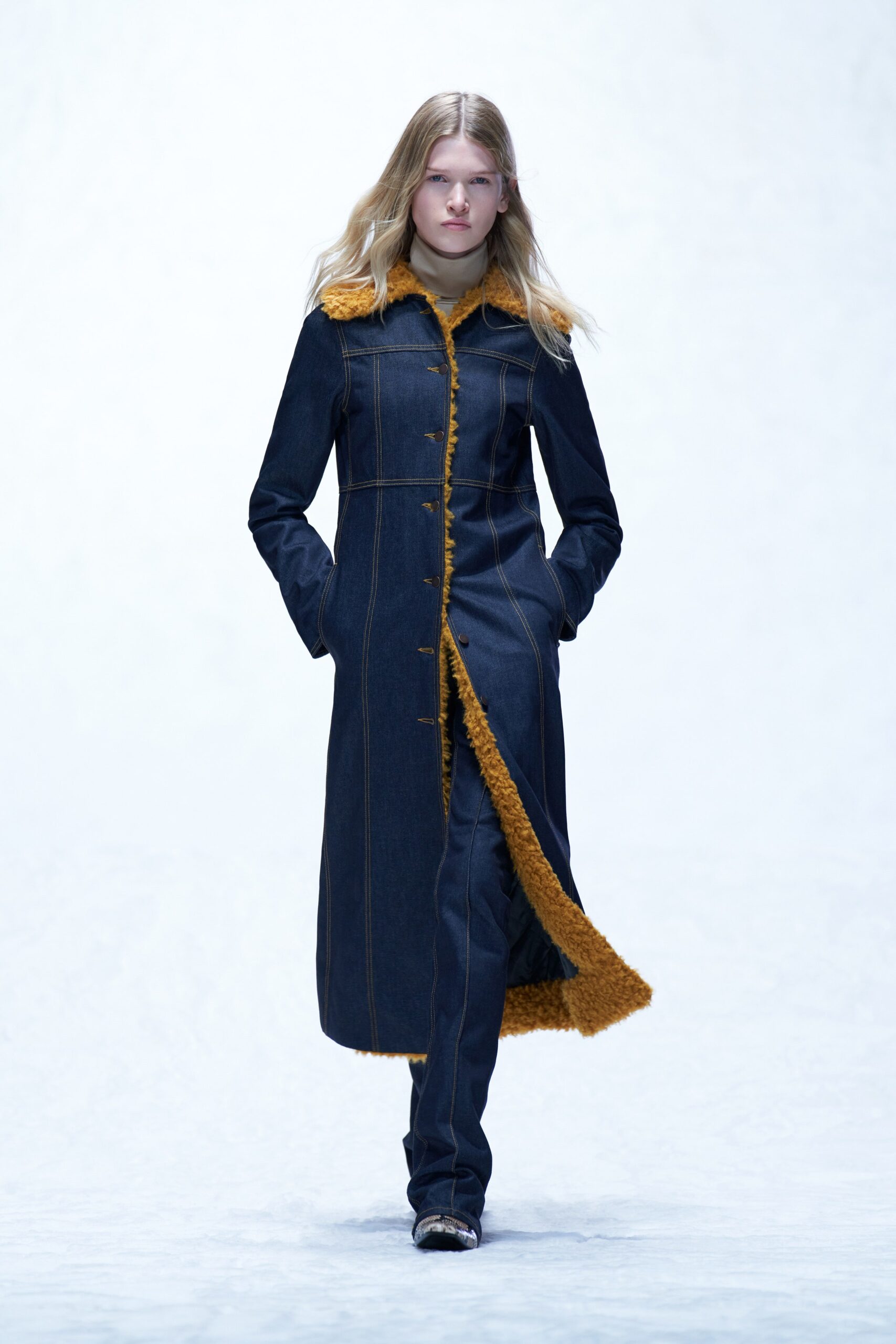 A fitted blue denim coat with brown fur collar and straight-leg pants.
