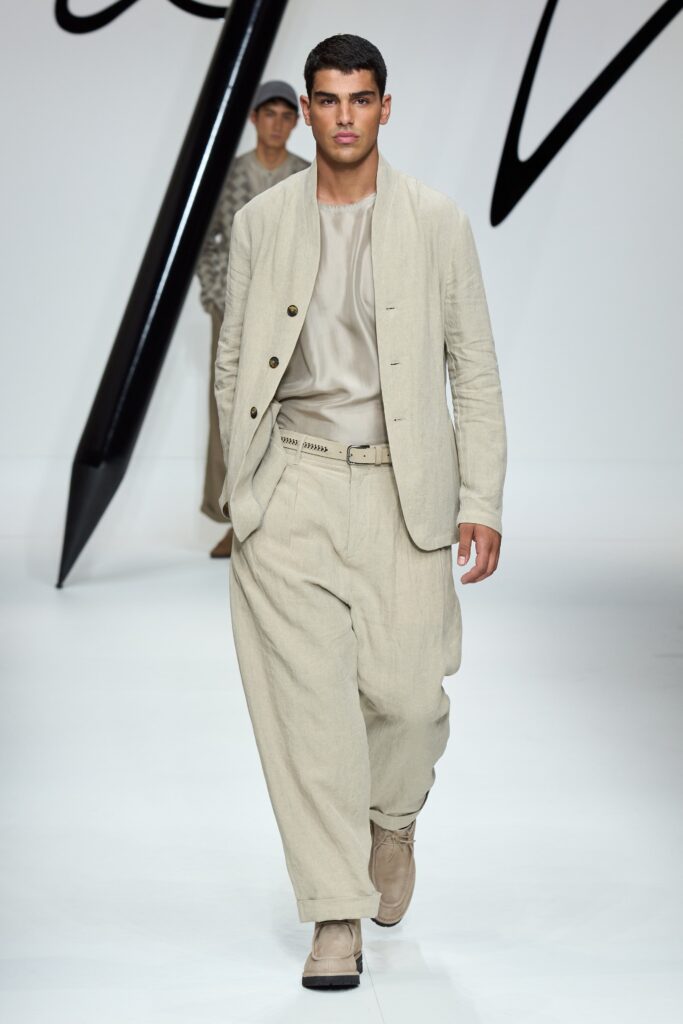 A relaxed beige cotton suit with a long-sleeve collared shirt and buttoned details.