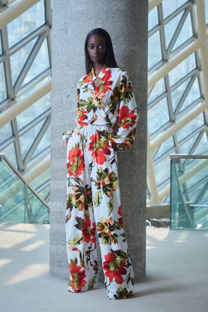 A relaxed floral jumpsuit with long sleeves and a collared neckline, featuring a wide-leg silhouette.