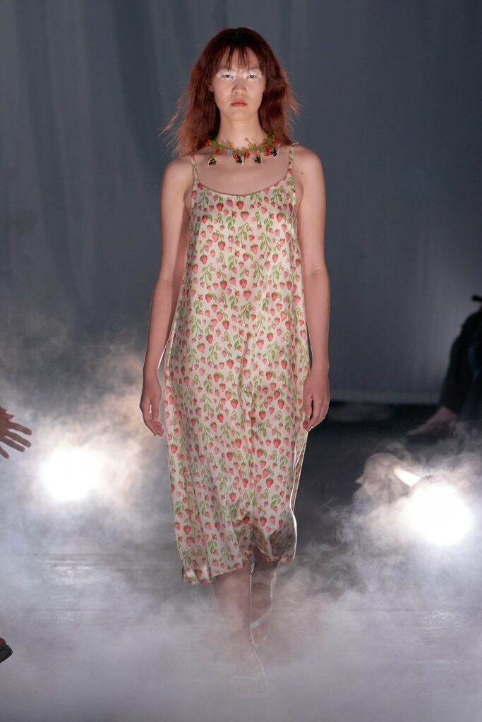 A relaxed cream floral sleeveless dress with a V-neckline, perfect for summer outings.
