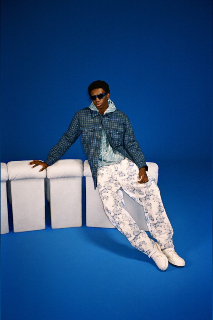 A relaxed blue printed jacket paired with white pants, perfect for a casual look.