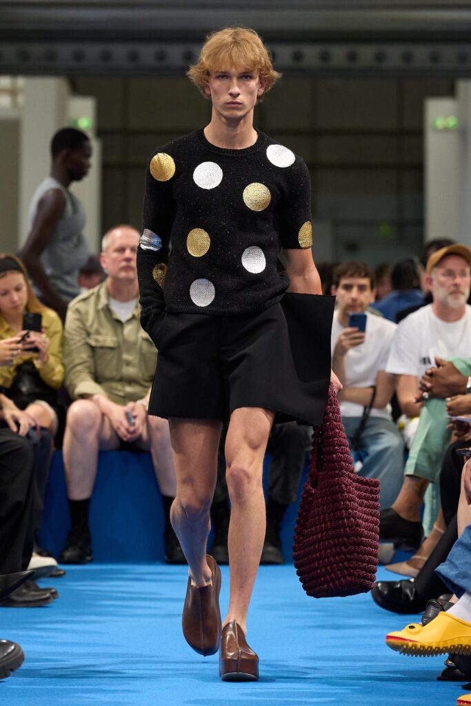 A fitted black cotton top with yellow polka dots paired with tailored shorts.