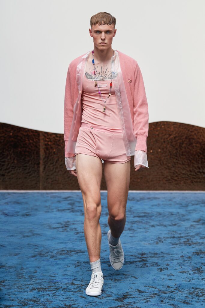 A fitted pink shirt with short sleeves and matching shorts, perfect for a stylish summer look.