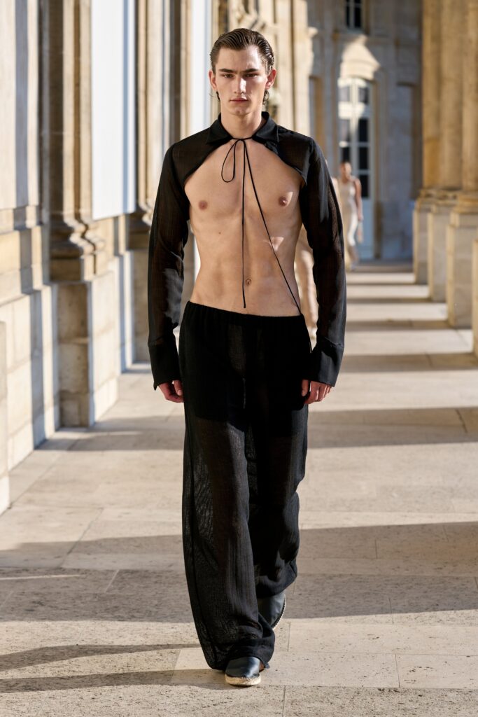 A relaxed black sheer long-sleeve shirt with a collared design and straight-leg pants.
