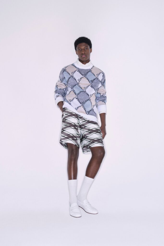 A relaxed fit blue printed sweater paired with stylish shorts.