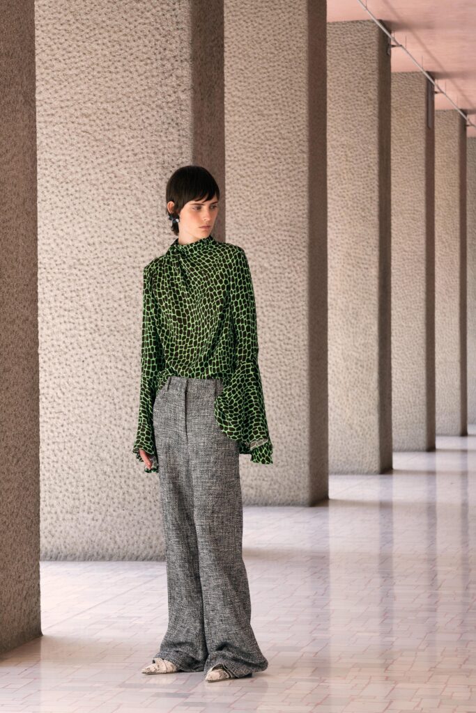 green printed fitted top and gray wide-leg pants