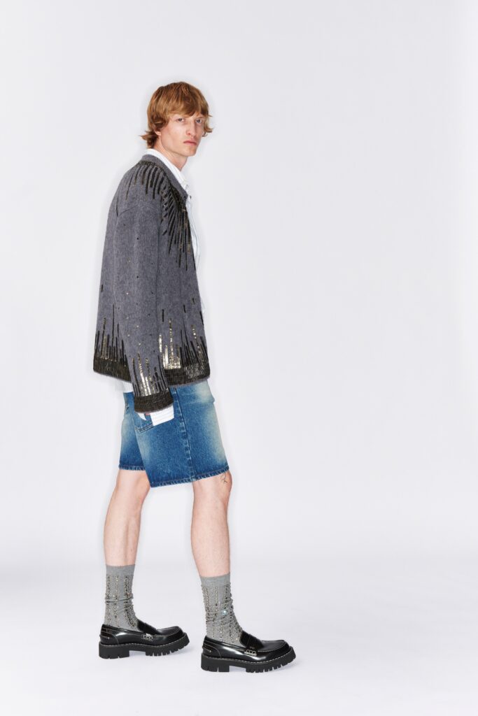 A relaxed gray embroidered jacket paired with blue denim shorts for a stylish look.