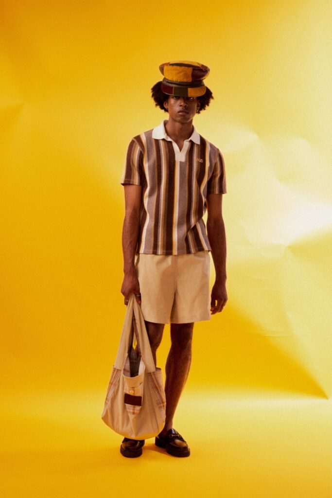 A relaxed brown striped short-sleeve shirt paired with beige shorts for a casual look.