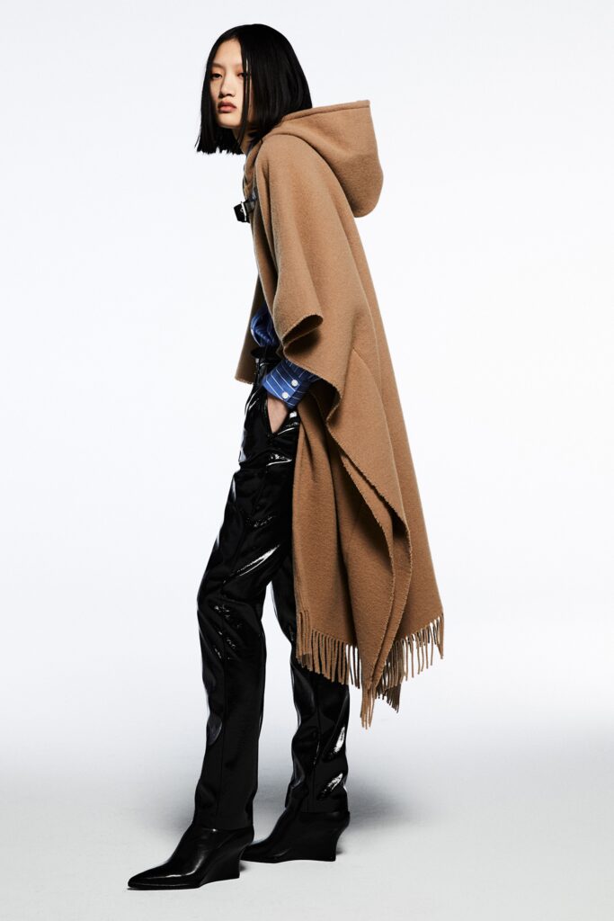 brown wool poncho with black vinyl pants