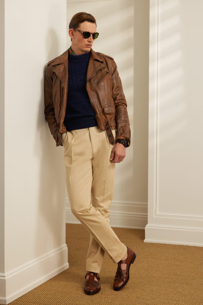 A fitted brown leather jacket paired with beige cotton pants, featuring a collared neckline.