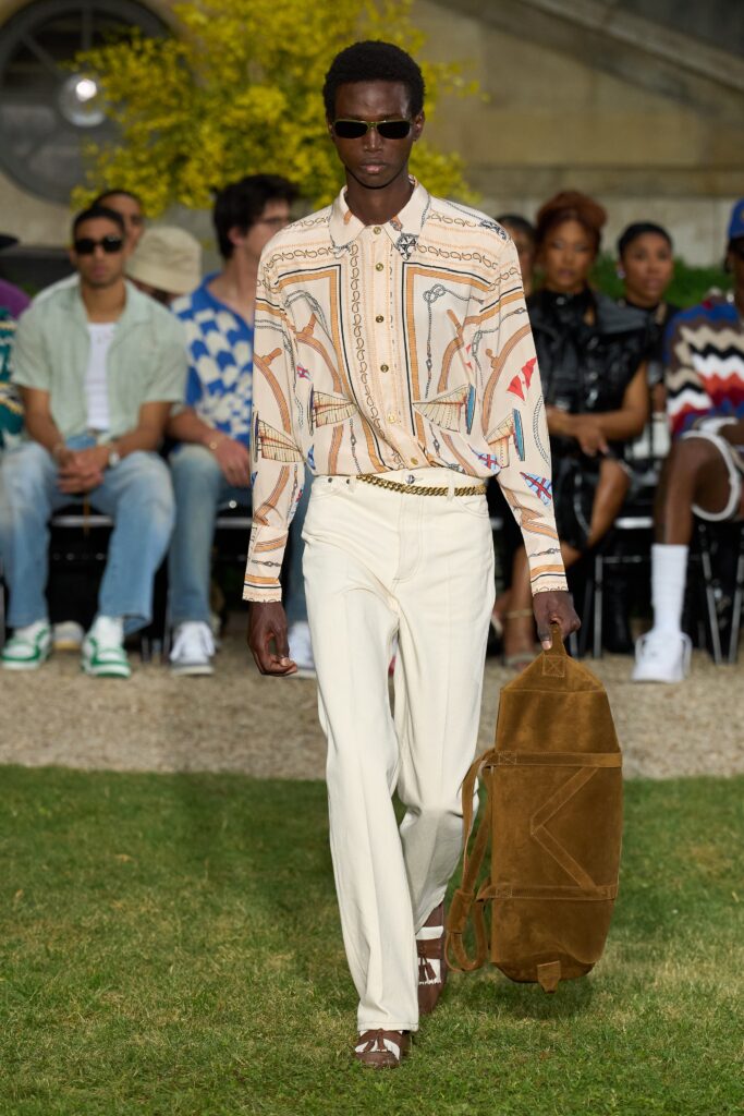 A relaxed-fit beige printed shirt paired with straight-leg white pants.