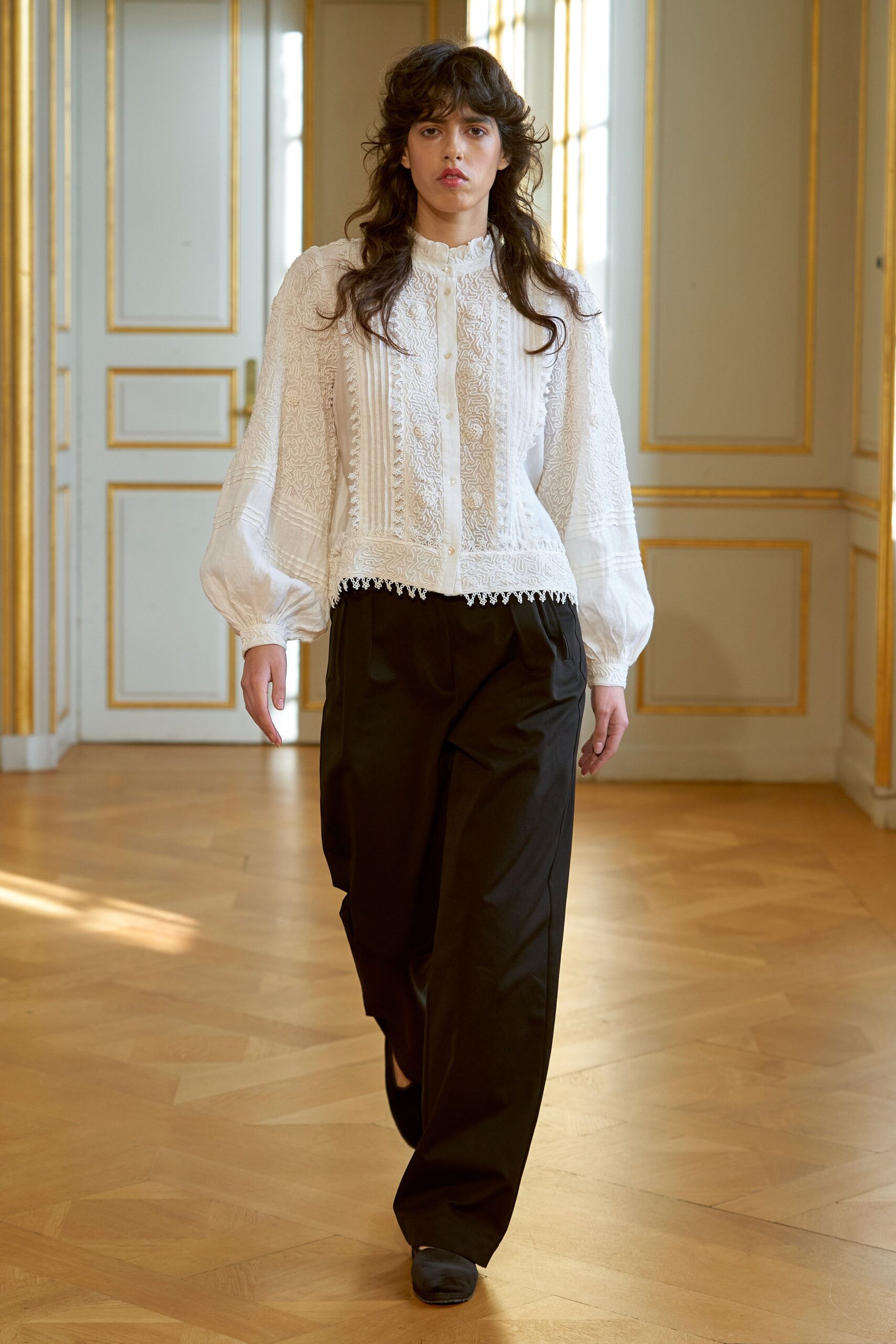 white embroidered blouse and black pants