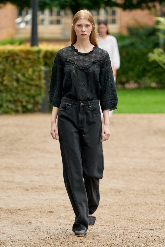 A relaxed black cotton blouse with long sleeves and embroidery, paired with black relaxed-fit pants.