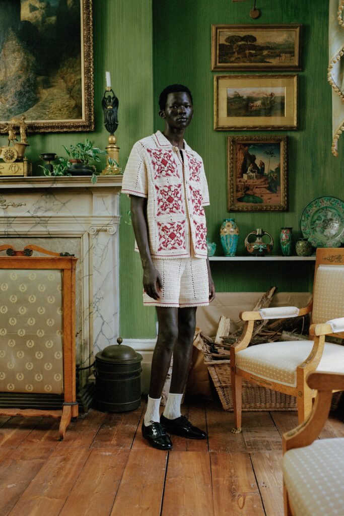 A relaxed white cotton shirt with red embroidery paired with matching shorts.