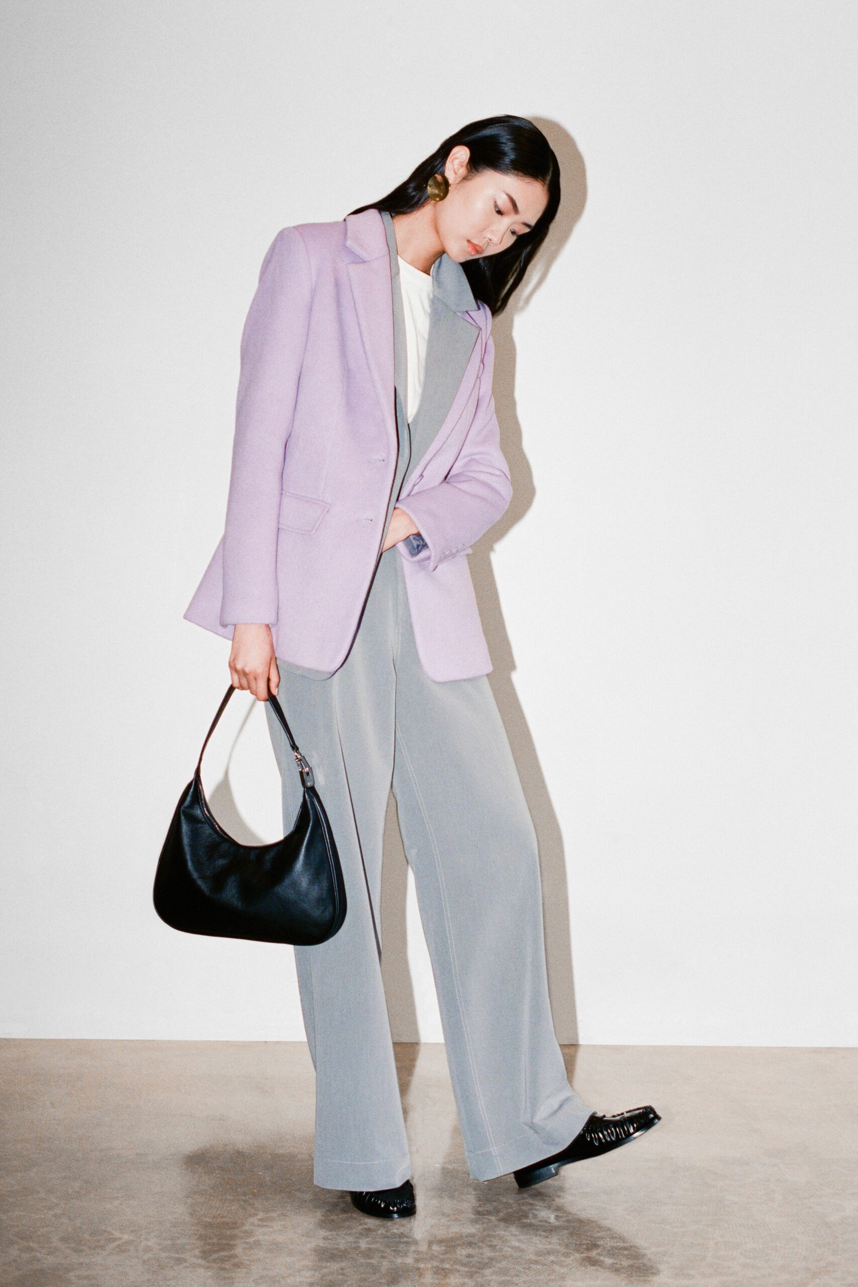 A tailored purple blazer paired with gray straight-leg trousers for a chic look.