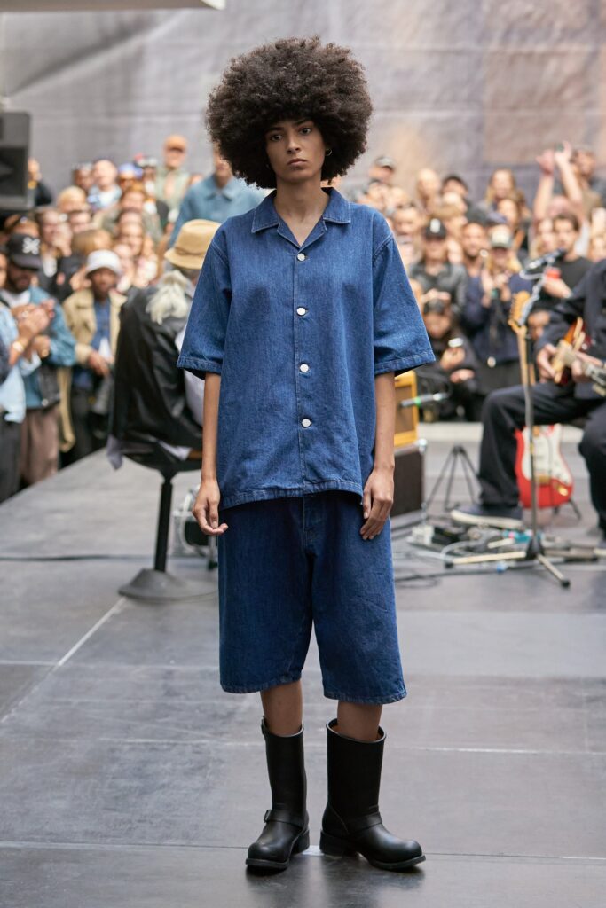 A relaxed blue denim shirt with short sleeves paired with matching denim shorts.