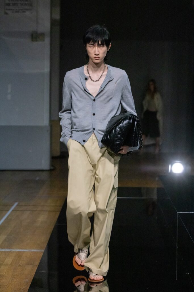 A relaxed gray cotton long-sleeve shirt with a collared design paired with beige pants.
