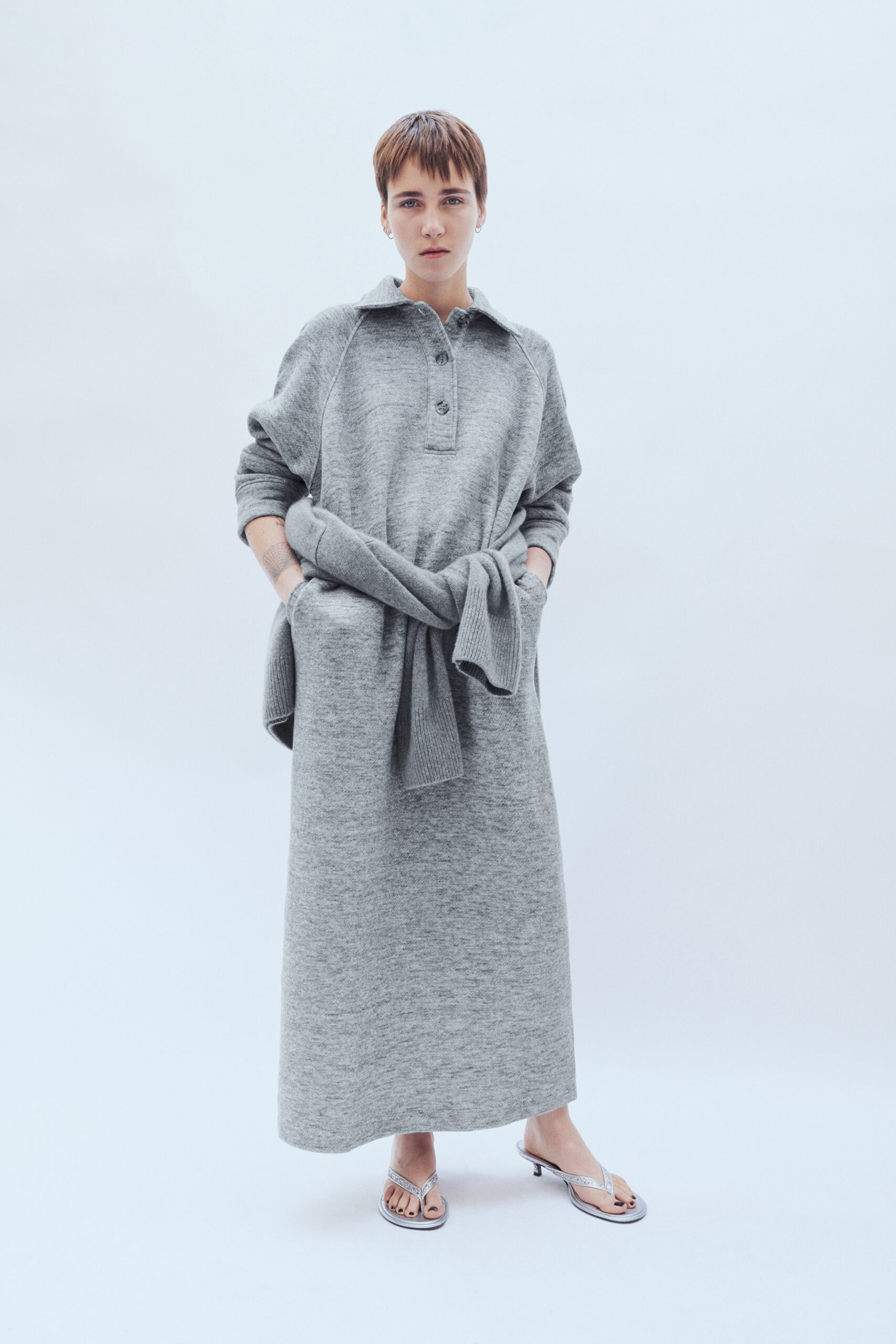 A relaxed gray cotton dress with long sleeves and a collared neckline.