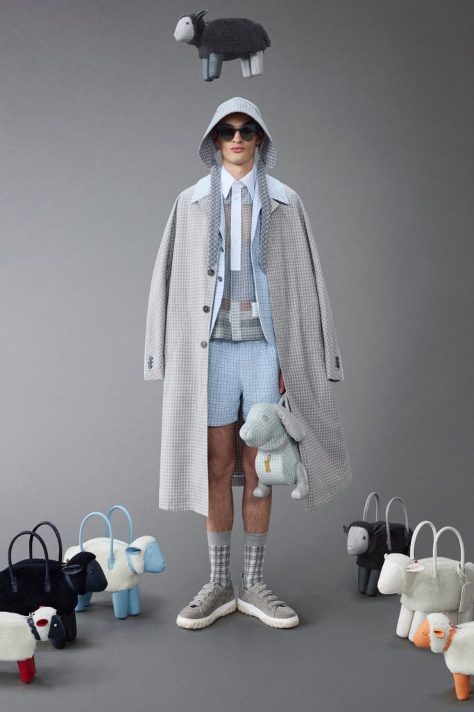 A relaxed gray checked coat paired with blue shorts, featuring a collared design.