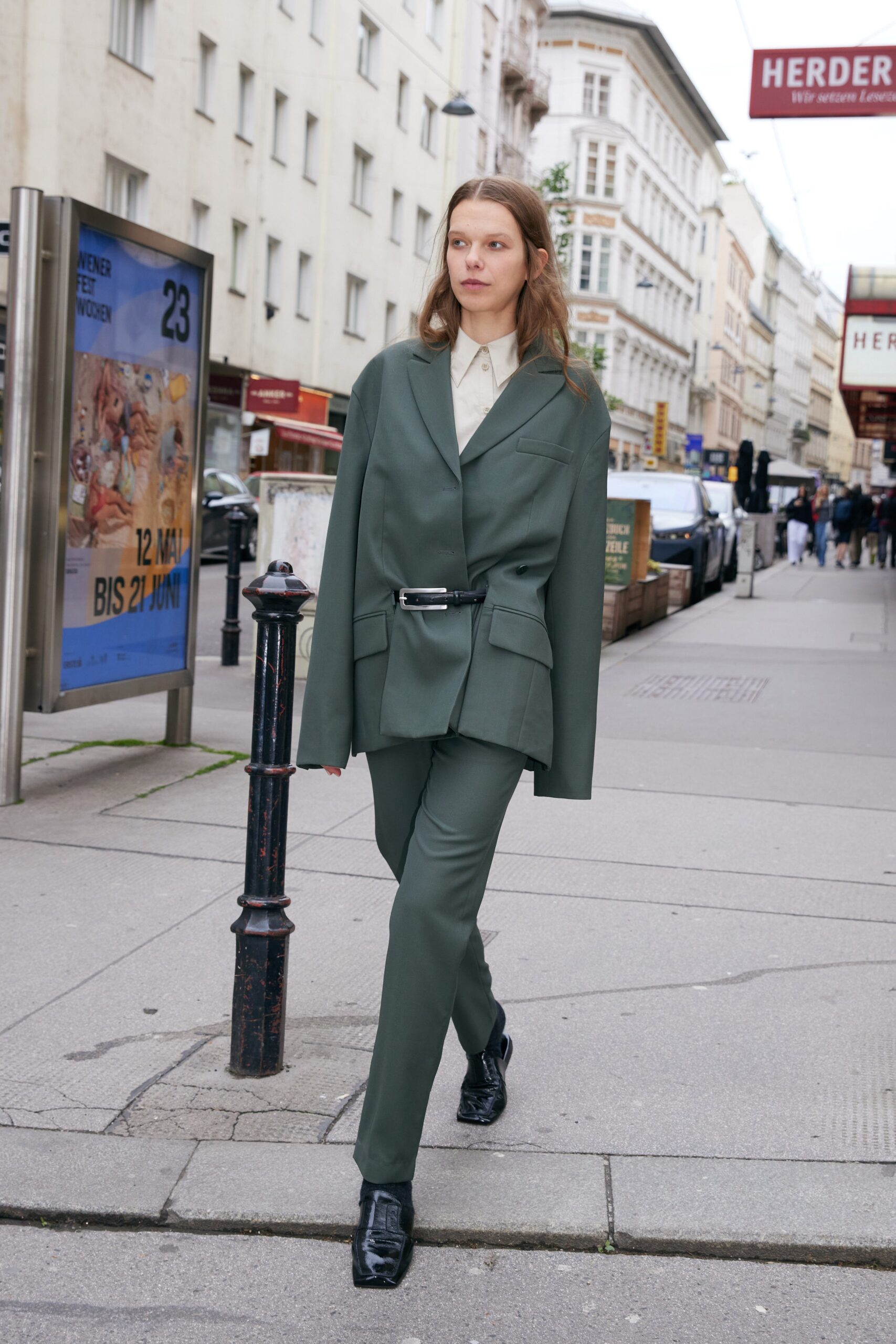 tailored green suit with black shoes