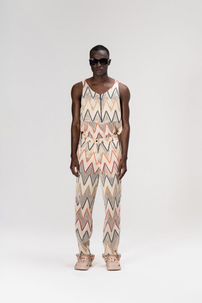 A fitted multicolor jumpsuit with a sleeveless design and zigzag pattern.