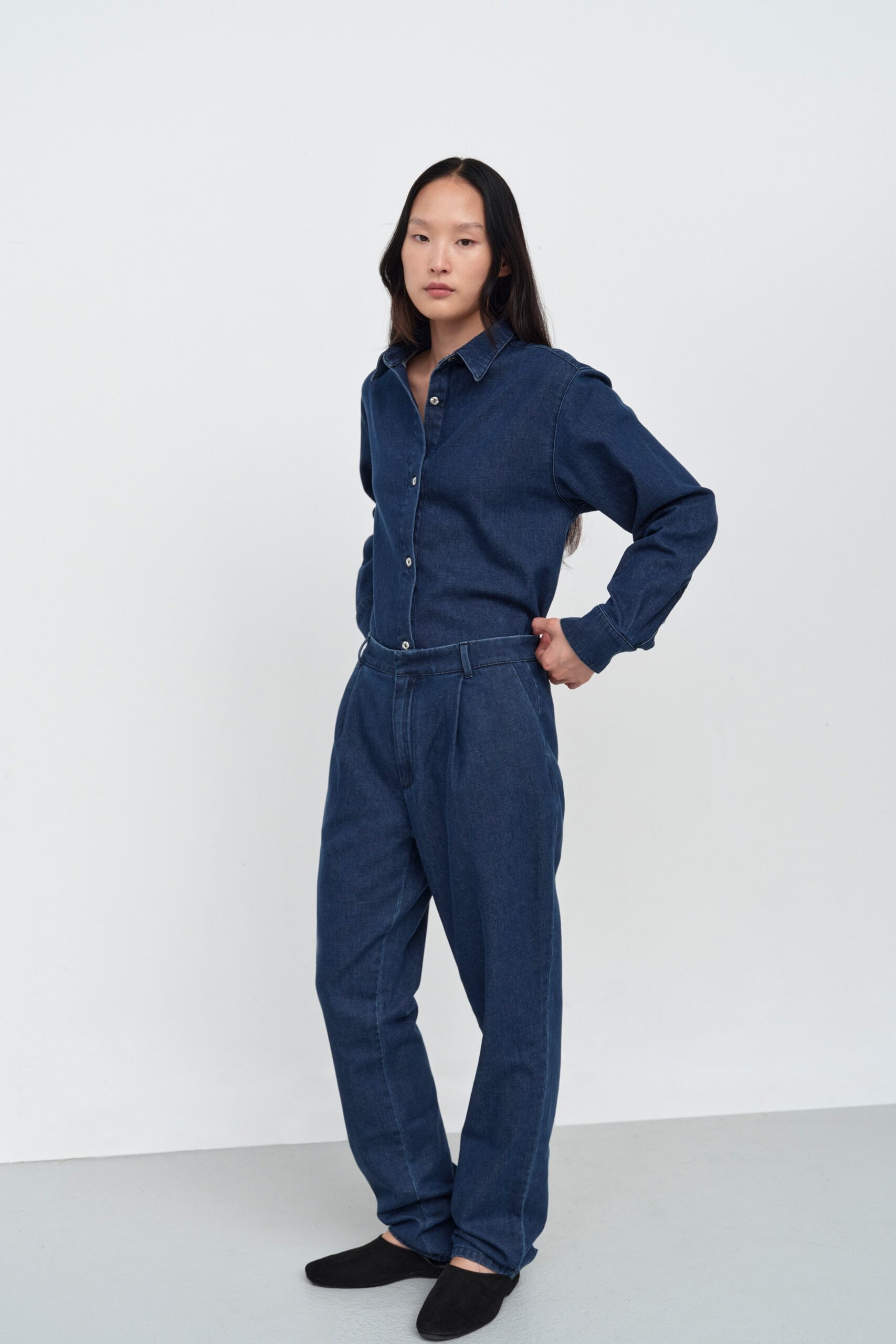 A relaxed blue denim long-sleeve shirt paired with straight-leg denim pants.