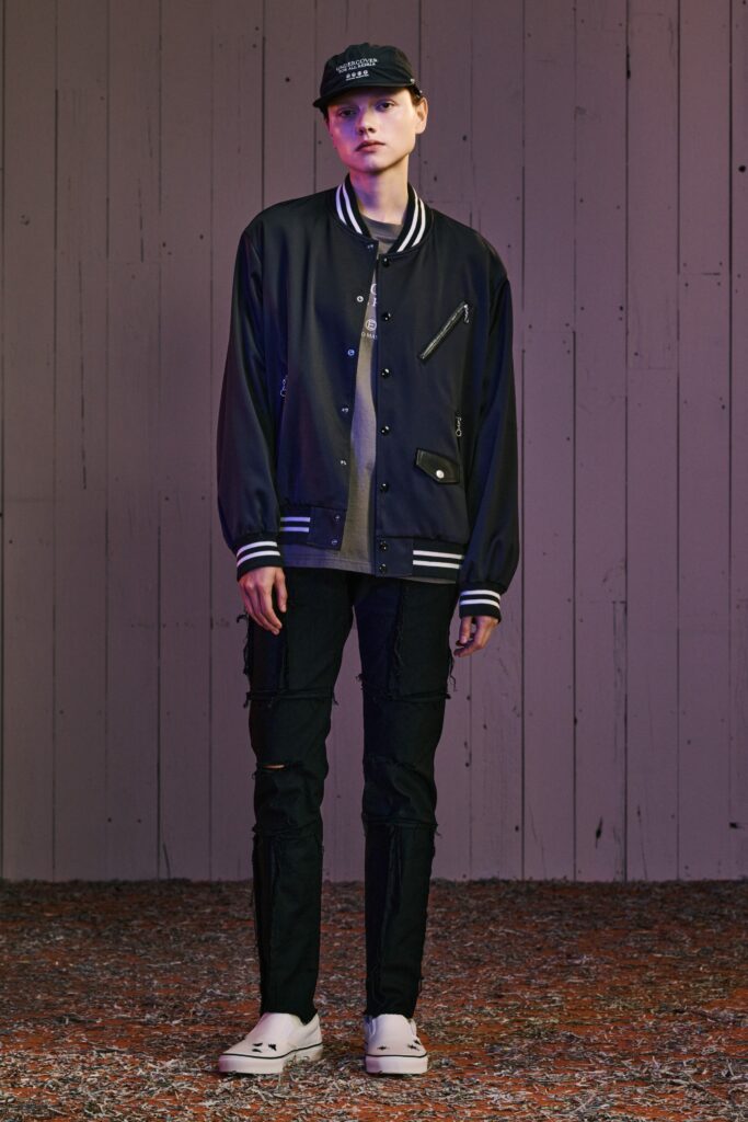 A relaxed black jacket with long sleeves and a collared design, paired with matching pants.