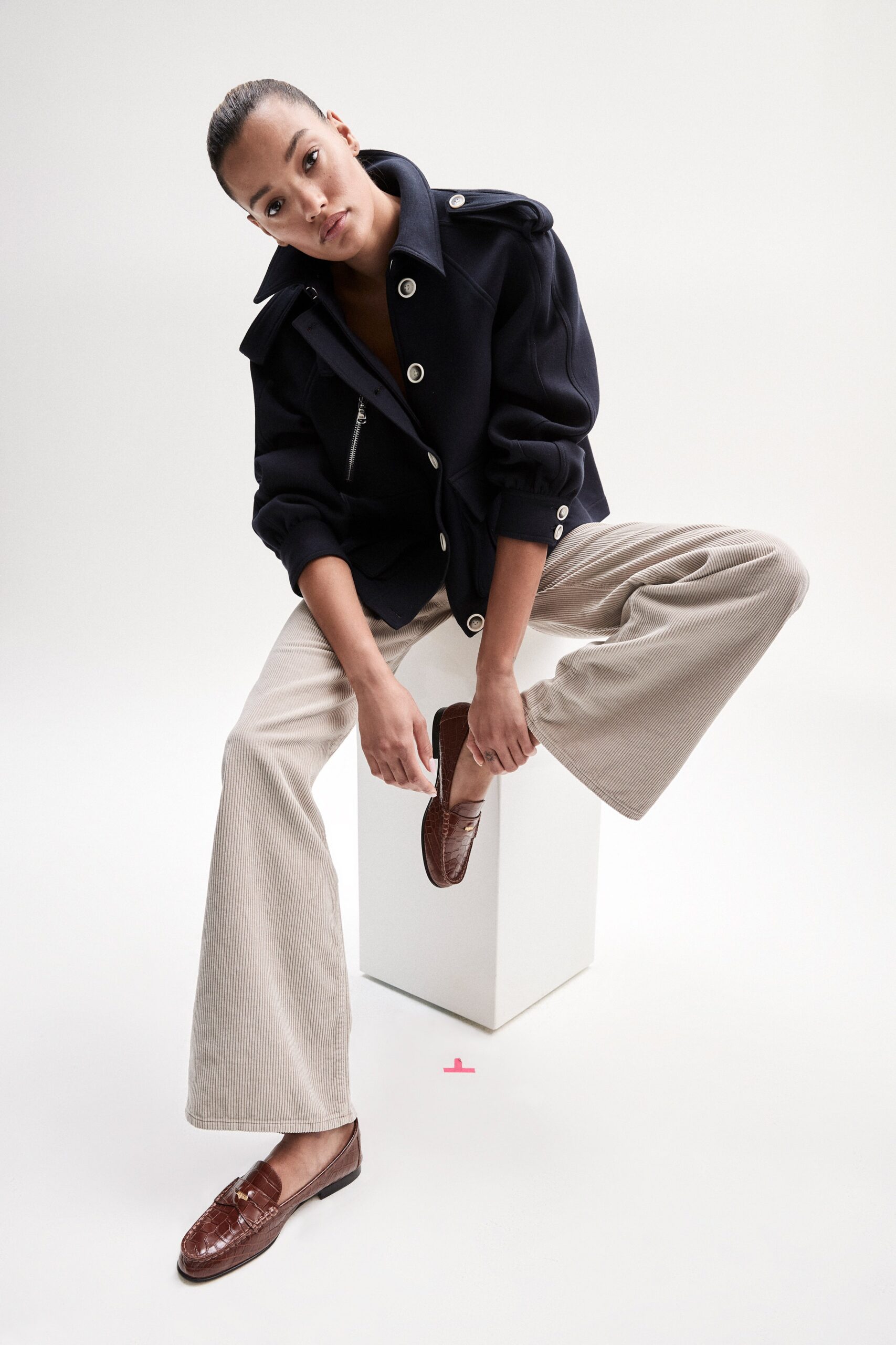 black relaxed jacket and beige wide-leg pants