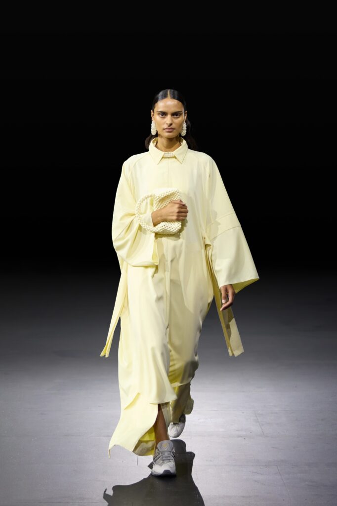 An oversized yellow long-sleeve dress with a relaxed fit and unique collar detail.