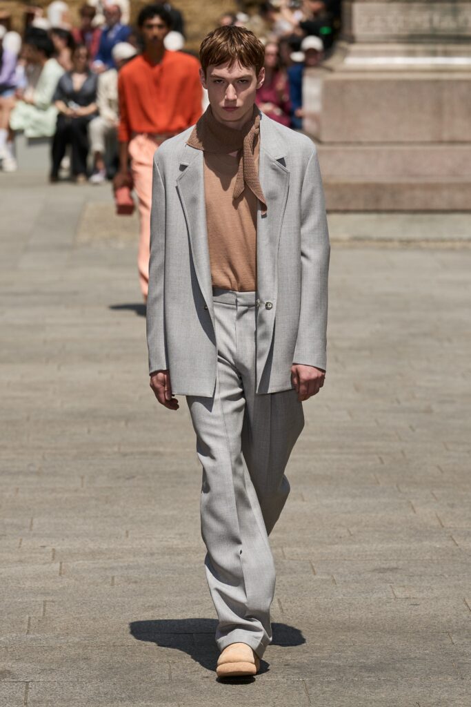 A tailored gray suit with a collared long-sleeve shirt and buttoned details.