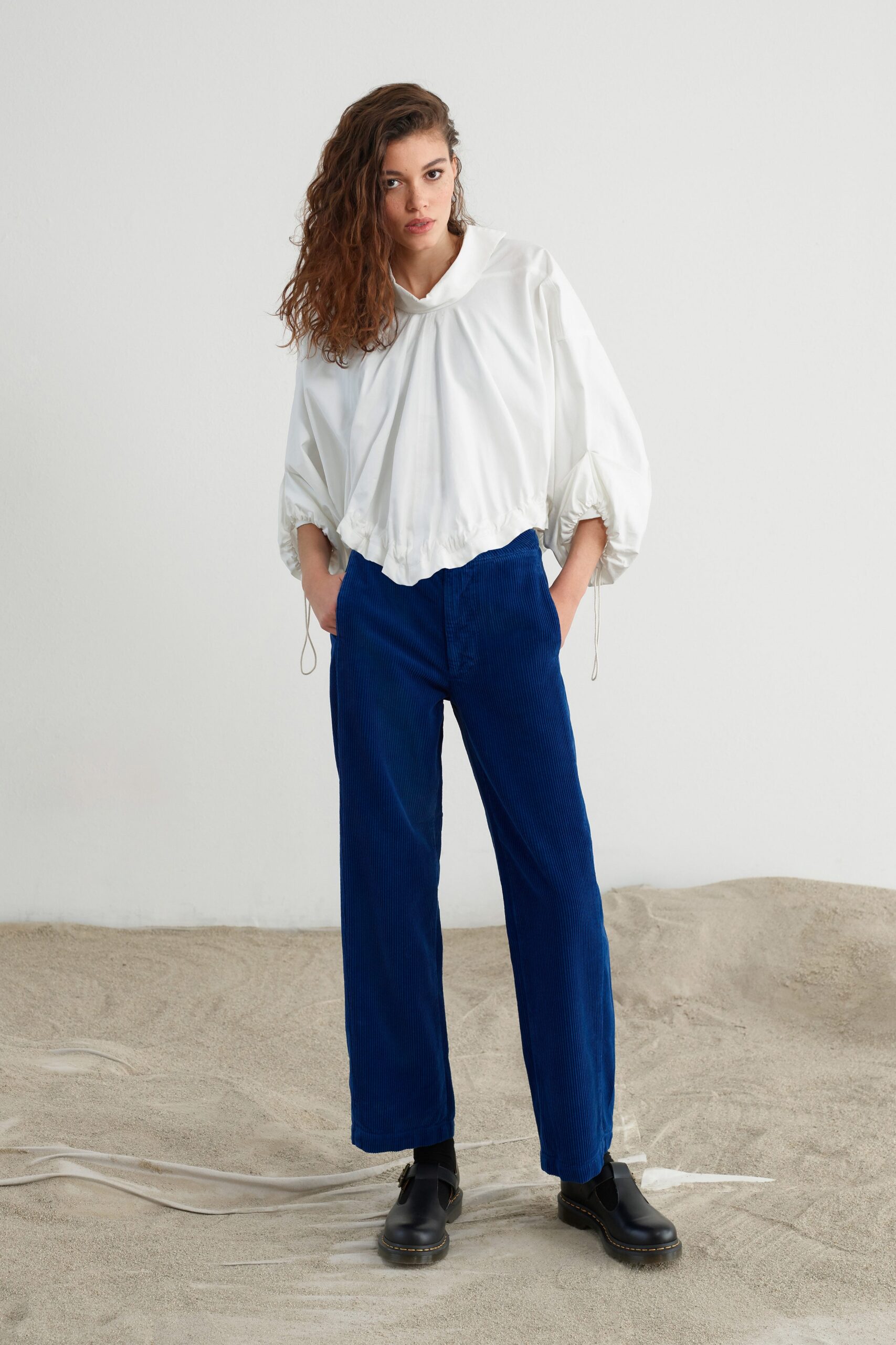 white relaxed blouse and blue pants