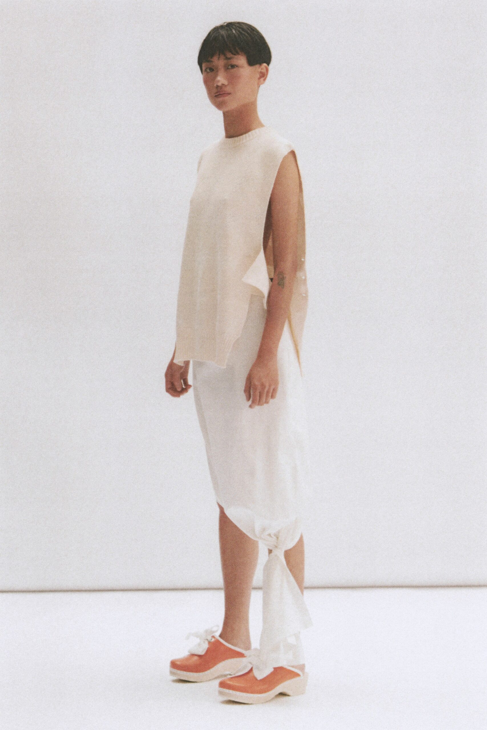 beige relaxed top with white skirt