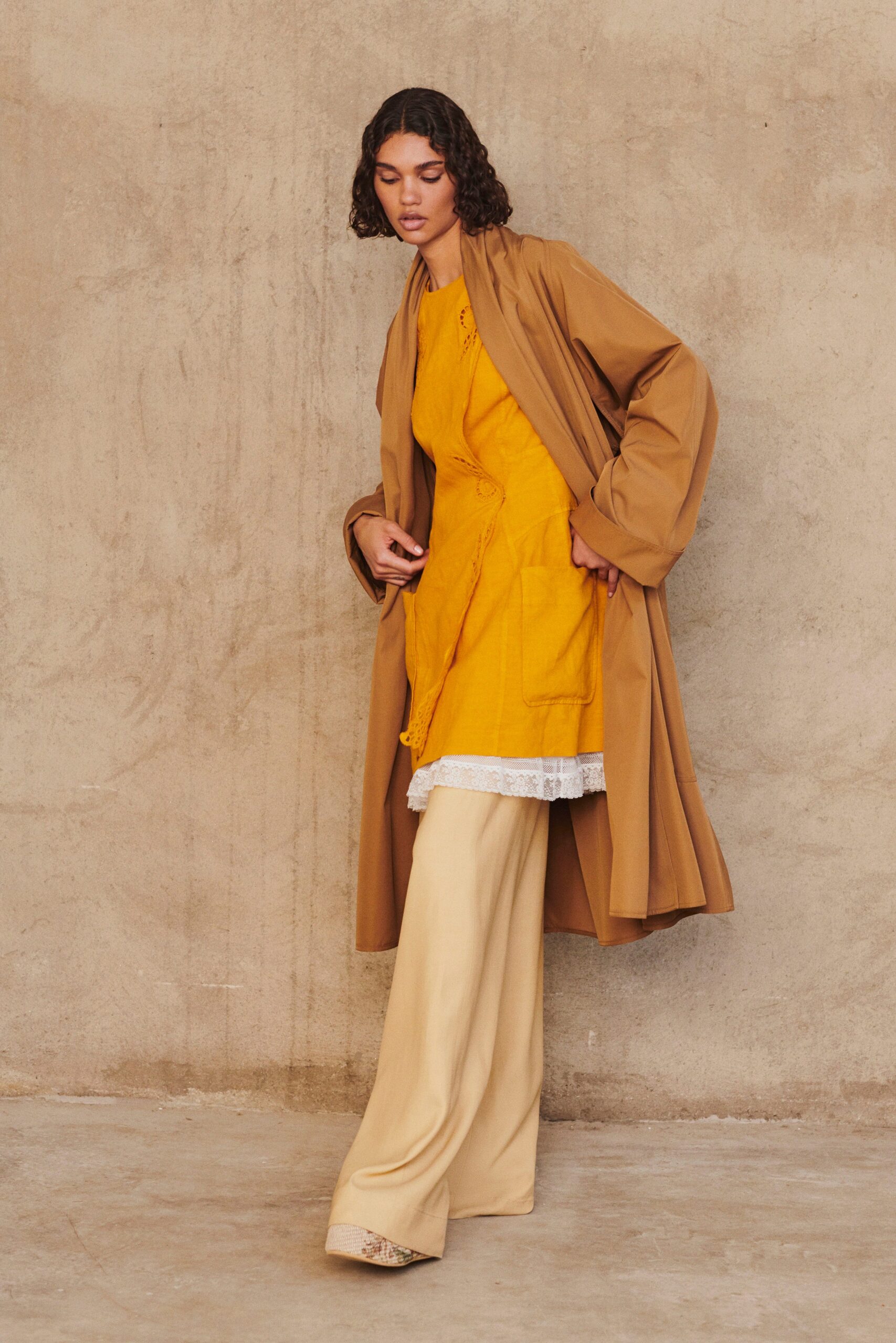 brown coat yellow dress beige pants
