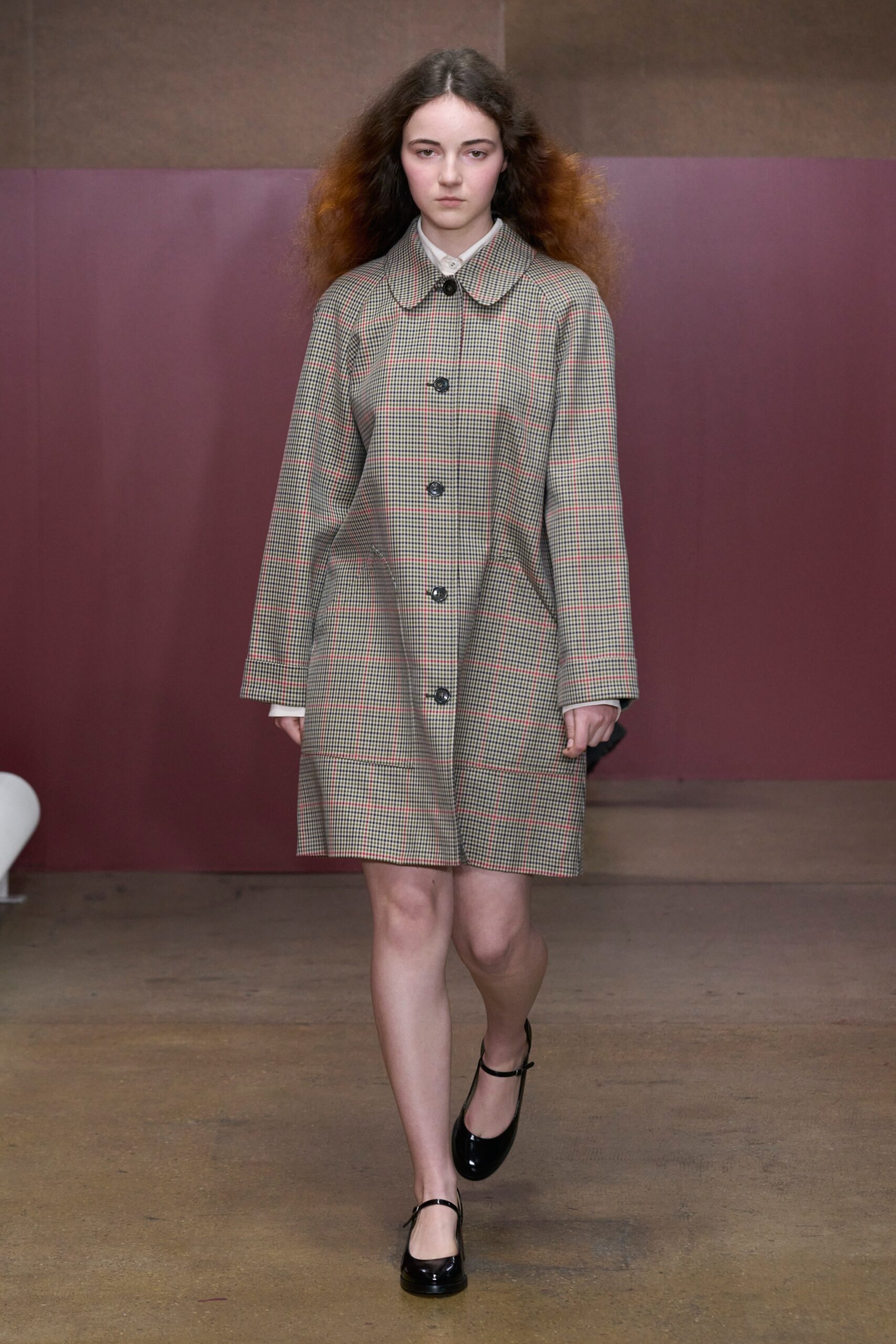 A relaxed brown and beige checked coat with long sleeves and a collared neckline.