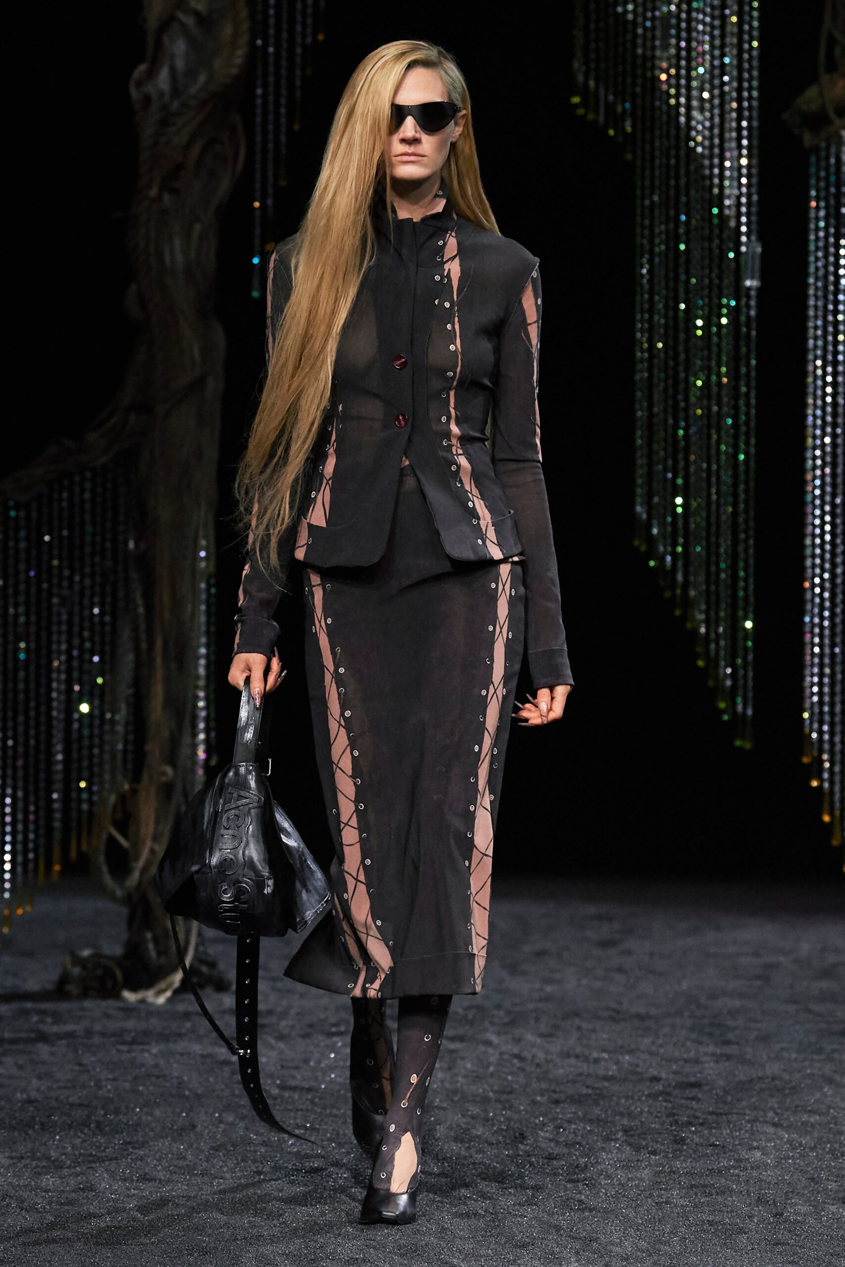 A fitted black silk dress with a collared long-sleeve jacket featuring an asymmetric design.