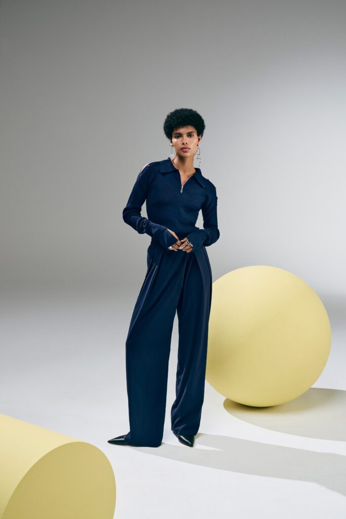 A relaxed navy cotton long-sleeve shirt paired with wide-leg pants for a chic look.