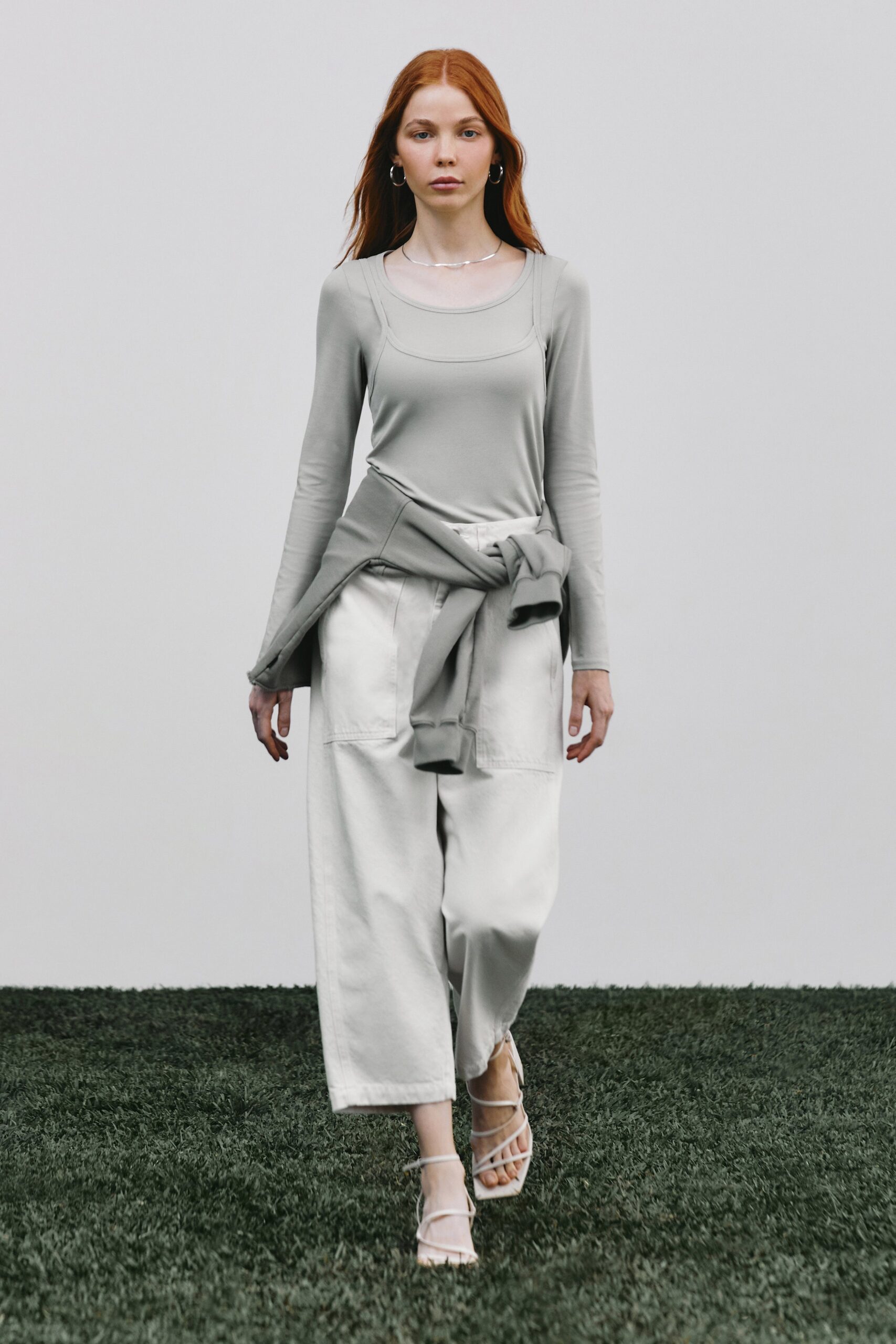gray fitted top with relaxed white pants