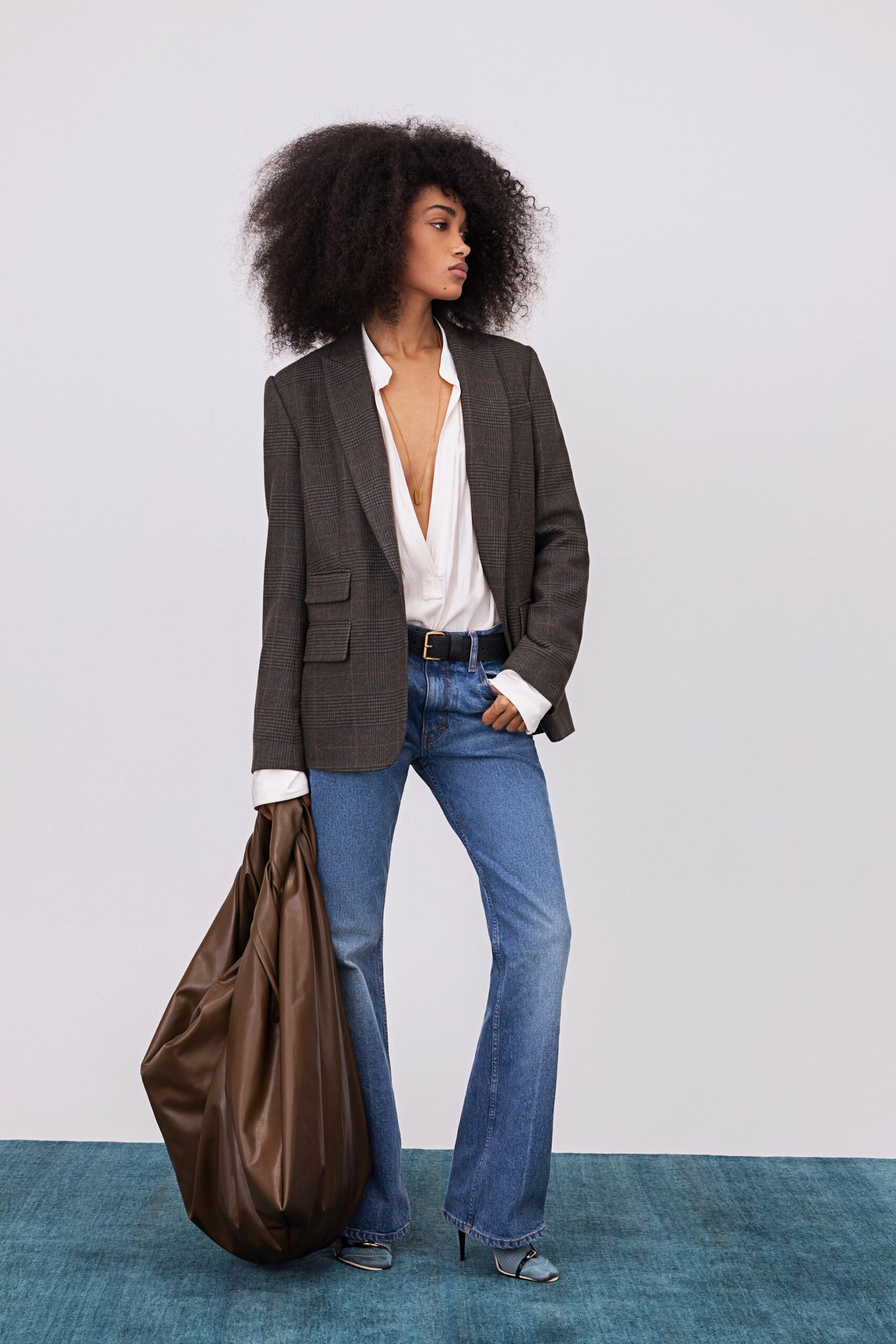 gray tailored blazer with flared jeans