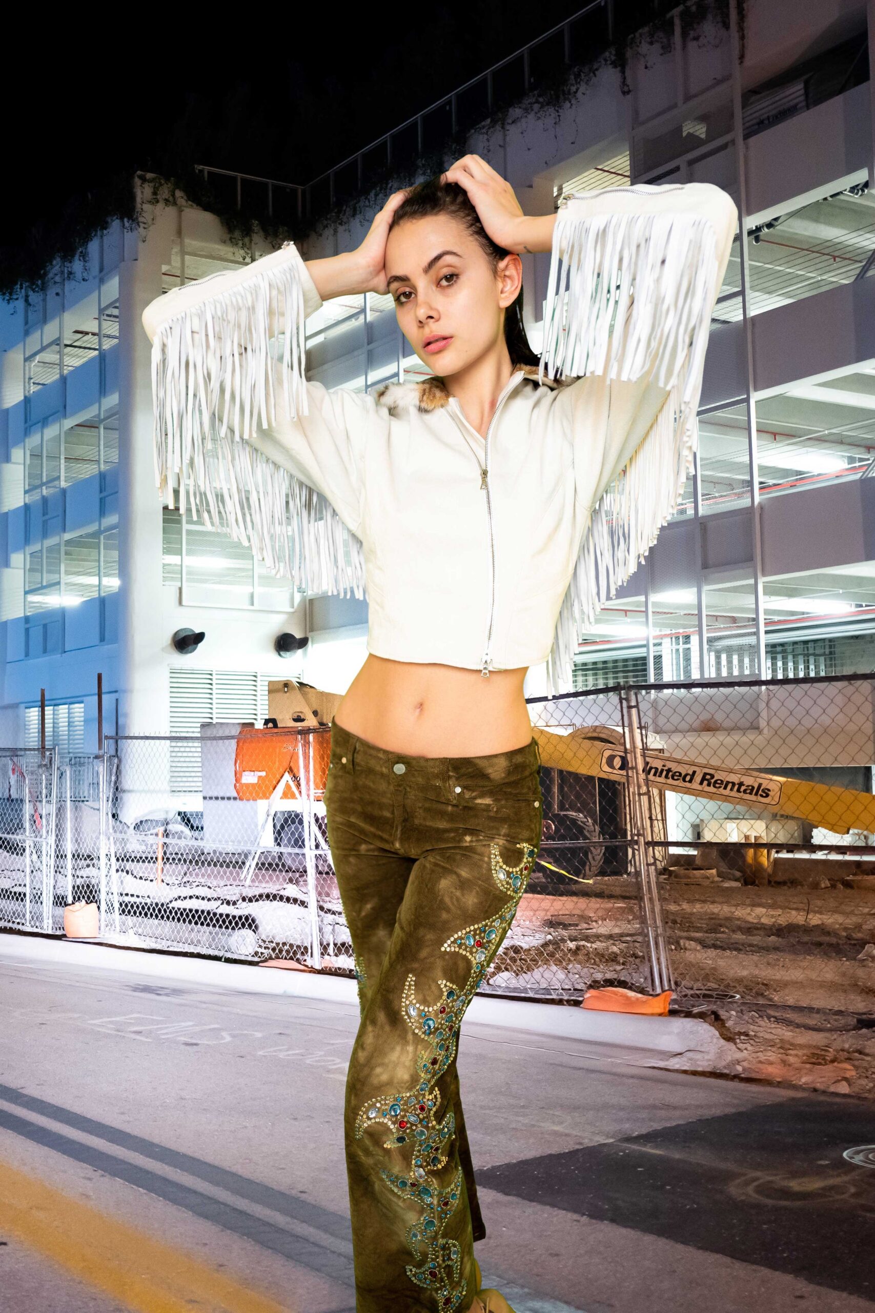 white fringed jacket and brown velvet pants