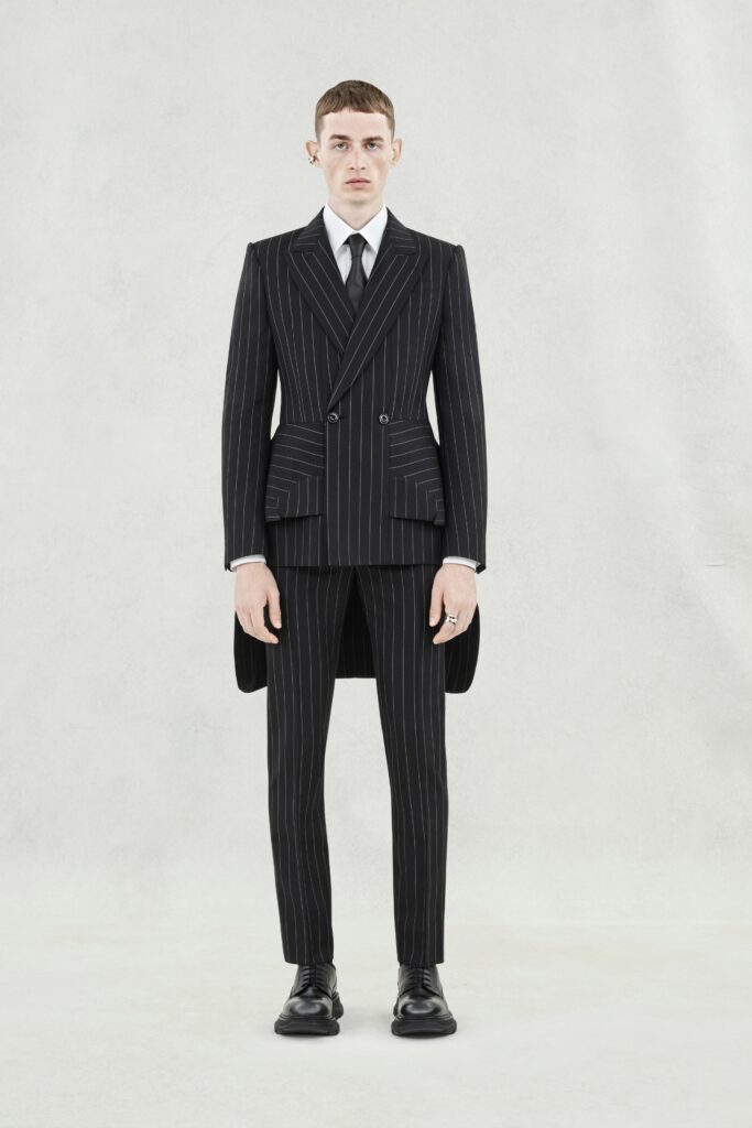 A tailored black striped suit with long sleeves and a double-breasted design.