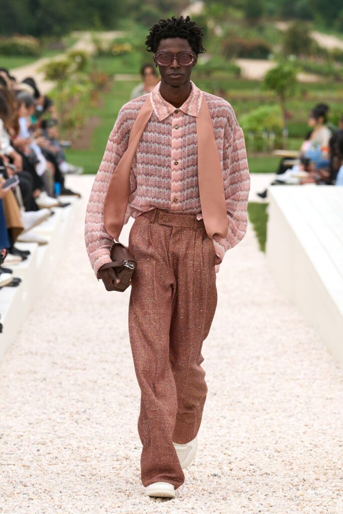 A relaxed pink striped long-sleeve shirt paired with wide-leg brown pants.