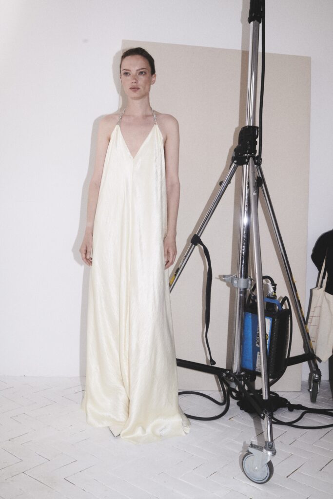 A relaxed cream silk sleeveless dress featuring a V-neckline and maxi length.