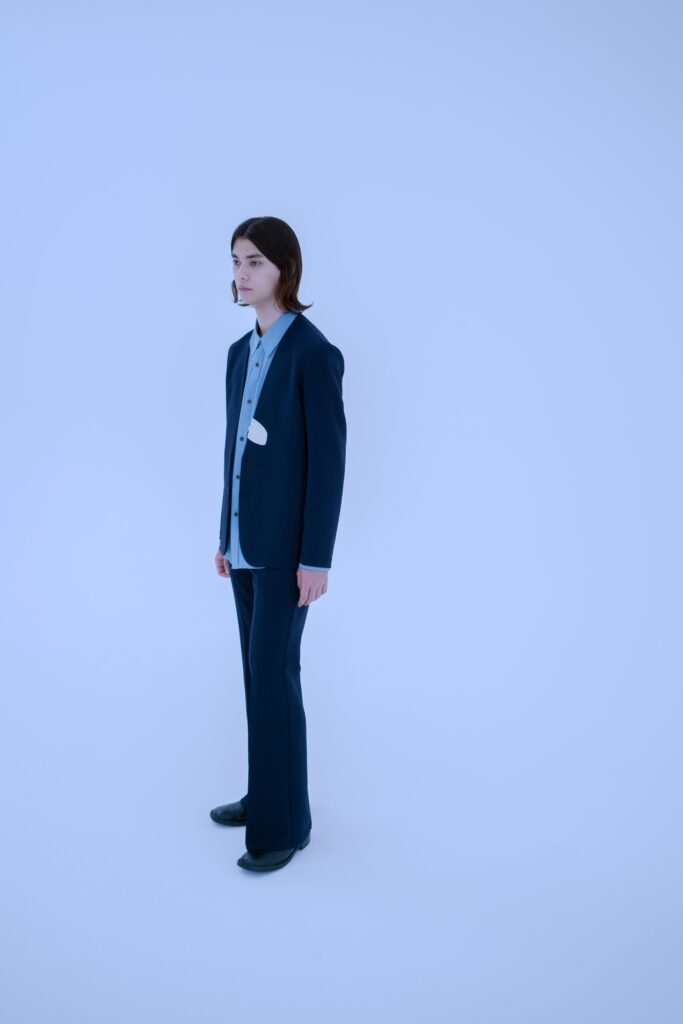 A tailored blue suit with a long-sleeve collared shirt and straight-leg pants.