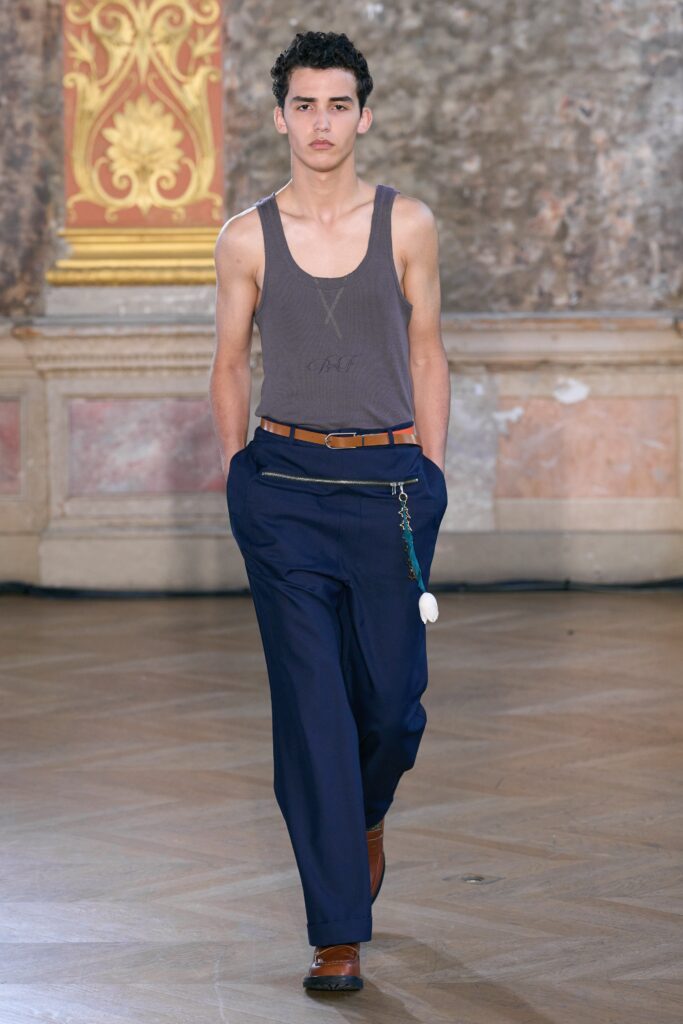 gray tank-top and blue pants