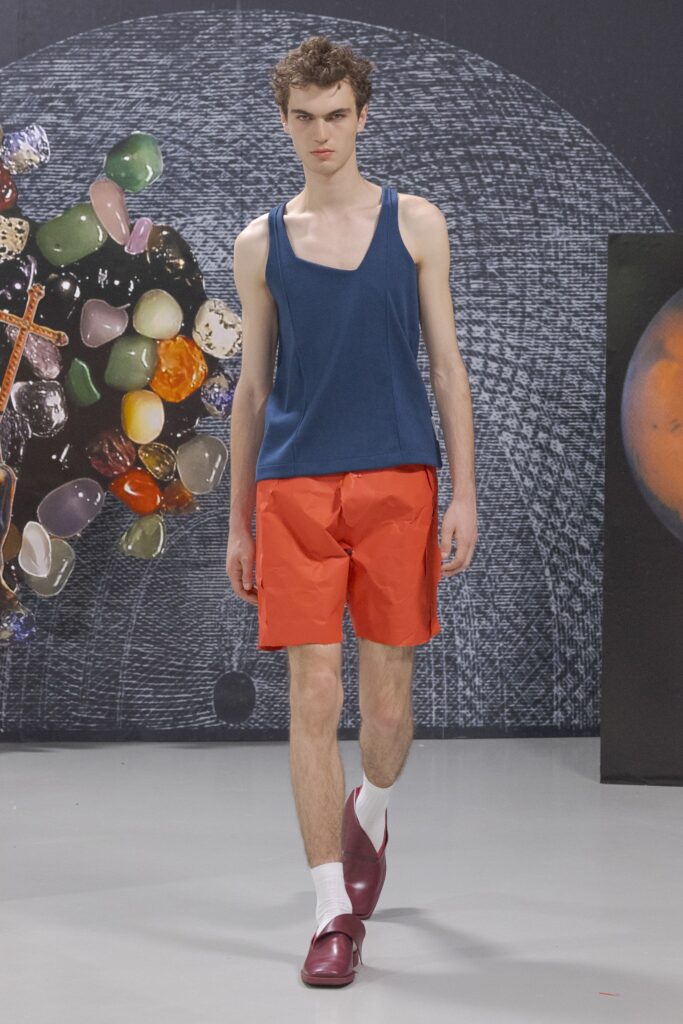 A fitted blue sleeveless top paired with vibrant red shorts, perfect for a casual summer look.