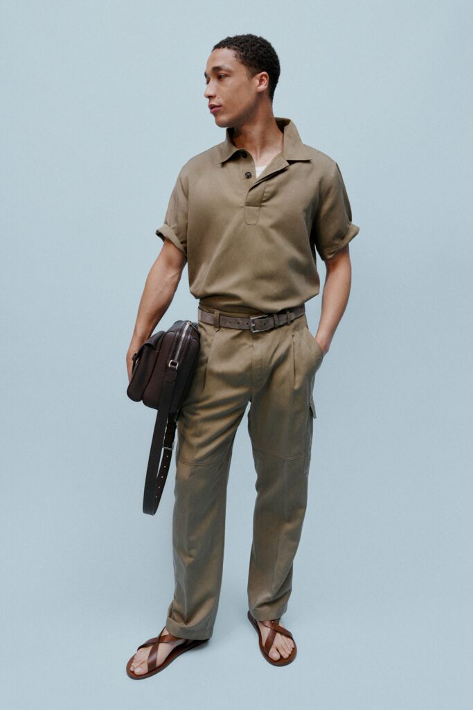 A relaxed beige cotton short-sleeve shirt paired with straight-leg pants.