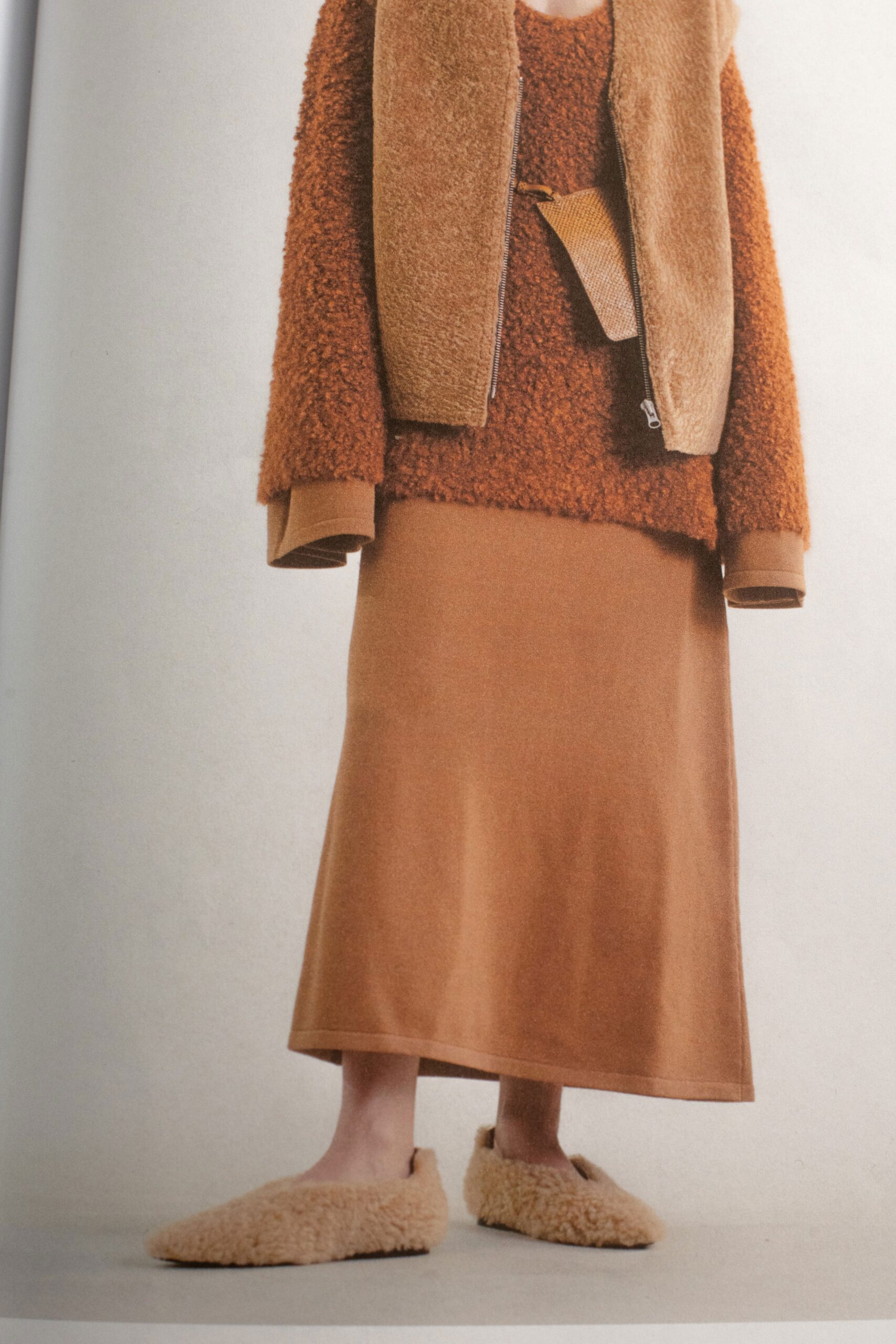 A relaxed brown wool sweater paired with a long skirt for a cozy look.